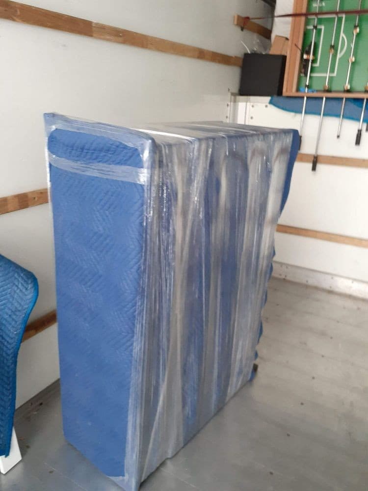 Mattress and furniture wrapped and secured inside a moving truck in Sacramento.
